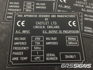 Black, engraved industrial rating plate divided into technical sections - all with white lettering and white border.