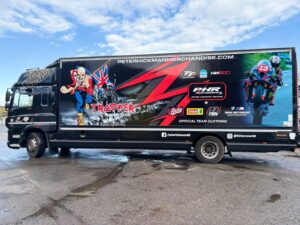 Side view of a black DAF CF box truck featuring a full promotional vehicle wrap for the Iron Maiden tribute act Hicksy Sixty.