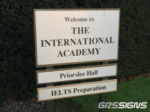 An engraved aluminium sign that welcomes visitors to The International Academy with Priorslee Hall
