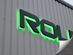 External 3D black lettering with green backlight. The 3D lettering is in black, with the photograph showing a close up angle of the sign - which spells "ROLEC" in a modern font.