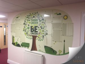 Large interior feature wall graphic and wall art promoting environmental sustainability, featuring a stylised tree with clear acrylic sign holders.