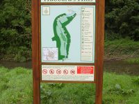 A bespoke wooden sign with a printed wayfinding map for Hubbard's Hills, Louth. The map has a key and the sign also features some safety warnings at the bottom.