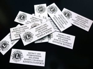 A close up of multiple laser-engraved name tags