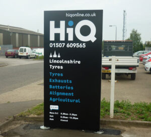 A modular sign for local business, HiQ (Lincolnshire Tyres) - predominantly black with white and blue text.