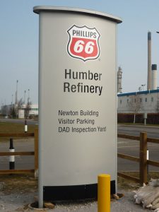 Modular sign for Humber Refinery. Sign is grey in colour with black text, and features a badge logo for "Phillips 66"