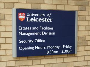 An external modular sign for the University of Leicester including opening hours.