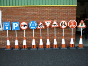 Highly bespoke traffic signs, mounted to traffic cones.