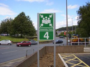 Dual-post mounted aluminium safety sign to mark a fire assembly point. (External sign that is post-mounted)
