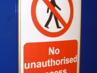 Door-fixed printed warning sign that reads "no unauthorised access"