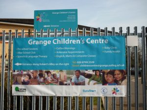 A large banner, attached via reinforced eyelets to outdoor fence railings, to advertise Grange Children's Centre.